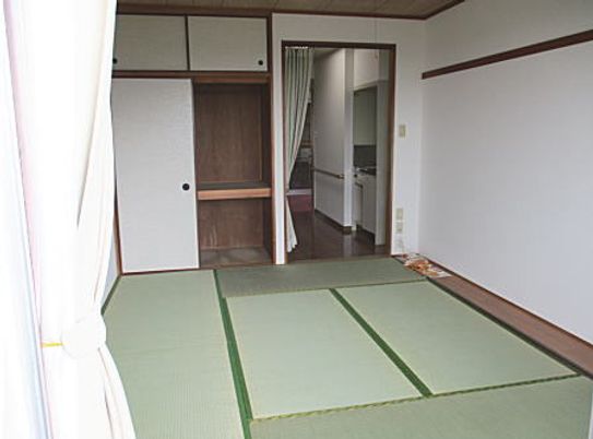本格的な畳敷きの和室には押し入れタイプの収納スペースが付き、カーテンの仕切りの奥にはキッチンもある。