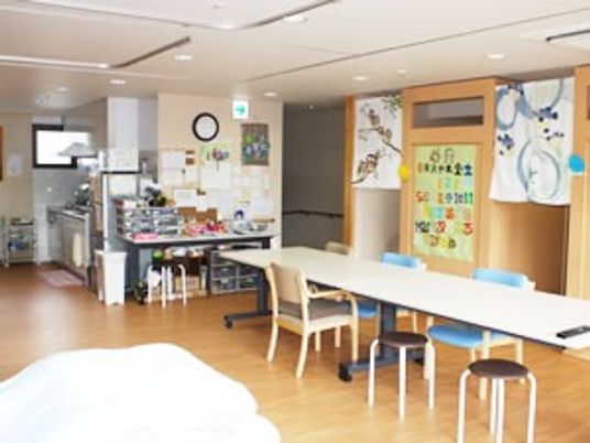 ダイニングテーブルの向こうにはキッチンが見える。木のぬくもりが感じられる館内。