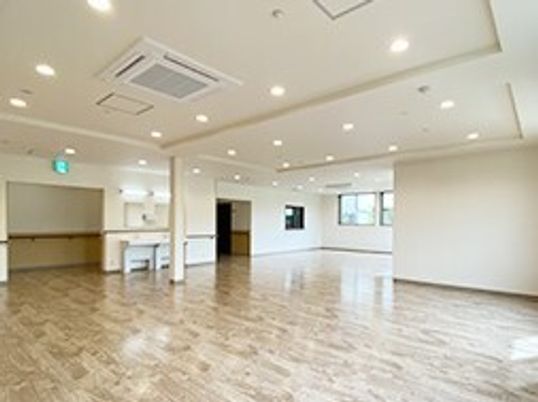 広々とした共有スペースには家具はなく、車いす対応のセメン所があり、窓が複数付いている。