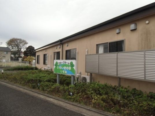 ベージュ色の外観と看板