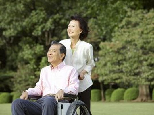 車椅子の男性と女性のスタッフ