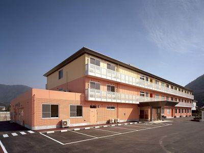 クリーム色の建物と駐車場