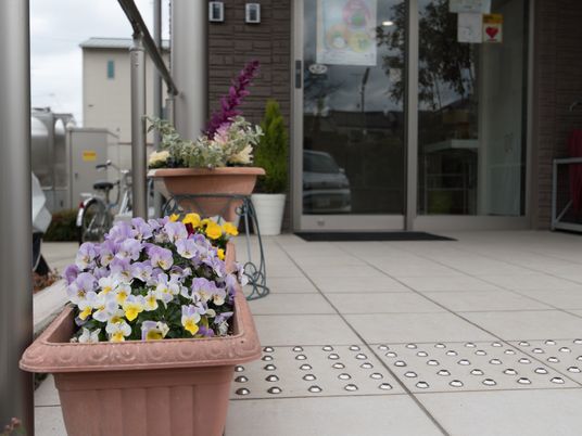 花とエントランスの施設前