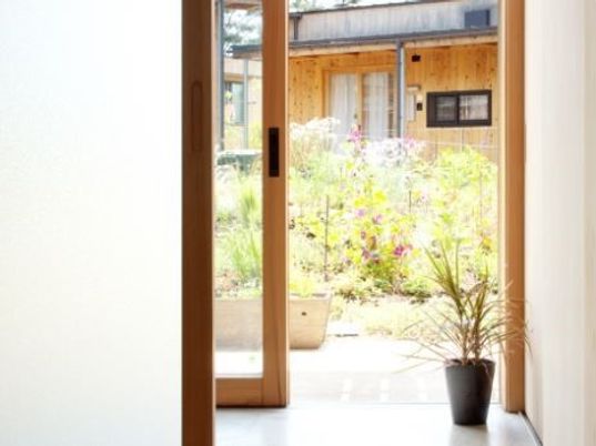 明るいエントランスからの庭の眺め