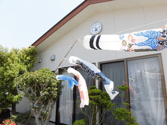 鯉のぼりと時計のある外観