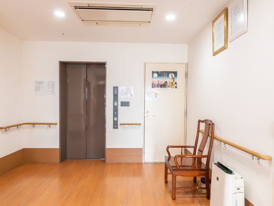 廊下にあるエレベーターと椅子