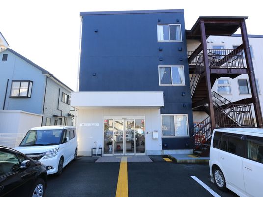 青い外壁の建物エントランス