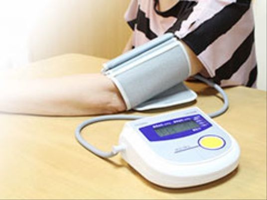 血圧測定をする腕