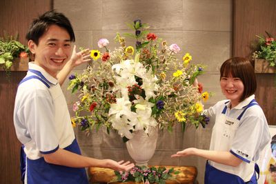 花を手に持つスタッフイメージ