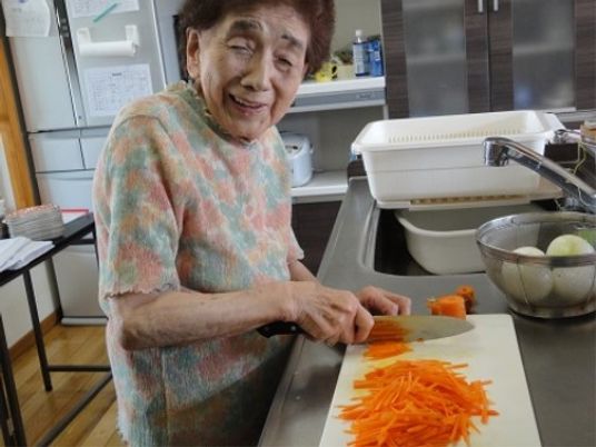 笑顔で調理する高齢者